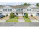 Charming townhomes featuring gray siding, blue shutters, well-manicured lawns, and individual garages at 1453 River Rock Ct, Oviedo, FL 32765