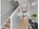Bright hallway with neutral walls, tile flooring, staircase, and a view into the living area at 1453 River Rock Ct, Oviedo, FL 32765