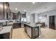 Well-appointed kitchen featuring an island with bar seating, dark cabinetry, and stainless steel appliances at 1453 River Rock Ct, Oviedo, FL 32765