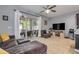 Bright living room with tile floors, ceiling fan, and sliding glass doors to the screened patio at 1453 River Rock Ct, Oviedo, FL 32765