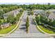 Street view of a gated community entrance, featuring lush landscaping and well-maintained streets at 1453 River Rock Ct, Oviedo, FL 32765