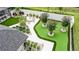 Aerial view of backyard oasis with manicured landscaping, patio, and inground pool at 1616 Turnbull Crossings Dr, New Smyrna Beach, FL 32168