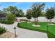 Beautifully landscaped backyard featuring a putting green, seating and a fire pit at 1616 Turnbull Crossings Dr, New Smyrna Beach, FL 32168