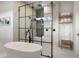 This bathroom features a modern tub, glass shower, and built-in shelving for linens at 1616 Turnbull Crossings Dr, New Smyrna Beach, FL 32168