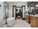 This bathroom features a modern tub, dual vanities, and a pass-through to the primary closet at 1616 Turnbull Crossings Dr, New Smyrna Beach, FL 32168