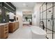 This bathroom features a modern tub, dual vanities, and a pass-through to the primary closet at 1616 Turnbull Crossings Dr, New Smyrna Beach, FL 32168