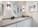 Stylish bathroom featuring a sleek vanity, oval mirror, modern lighting fixtures, and neutral decor at 1616 Turnbull Crossings Dr, New Smyrna Beach, FL 32168