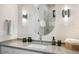 Stylish bathroom featuring a sleek vanity, oval mirror, modern lighting fixtures, and neutral decor at 1616 Turnbull Crossings Dr, New Smyrna Beach, FL 32168