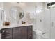 Bright bathroom featuring a modern vanity, round mirror, and a sleek glass-enclosed shower at 1616 Turnbull Crossings Dr, New Smyrna Beach, FL 32168