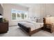 Bright bedroom with plantation shutters, modern decor, and a large window with outdoor views at 1616 Turnbull Crossings Dr, New Smyrna Beach, FL 32168