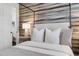 Cozy bedroom with a canopy bed, soft lighting, and elegant wallpaper, complemented by a glimpse into the bathroom at 1616 Turnbull Crossings Dr, New Smyrna Beach, FL 32168