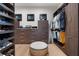 This walk-in closet features built-in shelving and storage for shoes and clothing at 1616 Turnbull Crossings Dr, New Smyrna Beach, FL 32168
