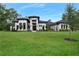 Stunning modern home with a well-manicured lawn and beautiful landscaping at 1616 Turnbull Crossings Dr, New Smyrna Beach, FL 32168