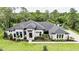 An aerial view of a two-story home showcasing the manicured lawn and professional landscaping at 1616 Turnbull Crossings Dr, New Smyrna Beach, FL 32168
