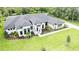 Aerial view showcasing the lush landscaping and well manicured lawn of the property at 1616 Turnbull Crossings Dr, New Smyrna Beach, FL 32168