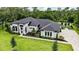 Aerial view of a two-story home with manicured lawn and professional landscaping at 1616 Turnbull Crossings Dr, New Smyrna Beach, FL 32168