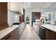 Modern kitchen with white marble backsplash, wood cabinets, stainless steel appliances, and hardwood floors at 1616 Turnbull Crossings Dr, New Smyrna Beach, FL 32168
