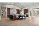 Gourmet kitchen with wooden cabinets, marble counters, modern lighting, and banquette seating at 1616 Turnbull Crossings Dr, New Smyrna Beach, FL 32168