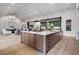 Open concept kitchen with a large island, wood cabinets, and seamless connection to the outdoor living space at 1616 Turnbull Crossings Dr, New Smyrna Beach, FL 32168