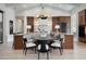 Chic kitchen with wood cabinets, island seating, stylish lighting, and stainless steel appliances at 1616 Turnbull Crossings Dr, New Smyrna Beach, FL 32168