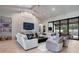 Inviting living room with vaulted ceilings, a cozy fireplace, and access to the outdoor patio at 1616 Turnbull Crossings Dr, New Smyrna Beach, FL 32168