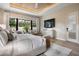 Serene main bedroom with a view of the screened-in patio, a TV, and a spa-like bathroom at 1616 Turnbull Crossings Dr, New Smyrna Beach, FL 32168