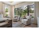 Inviting seating area in the main bedroom with a view of the private screened-in backyard at 1616 Turnbull Crossings Dr, New Smyrna Beach, FL 32168