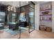 Modern office design with a glass door, sleek desk, and decorative shelves at 1616 Turnbull Crossings Dr, New Smyrna Beach, FL 32168