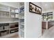 Walk-in pantry with organized shelving, ample storage space, and a view of the kitchen at 1616 Turnbull Crossings Dr, New Smyrna Beach, FL 32168