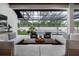 Outdoor patio with comfortable seating overlooking a pool and landscaped backyard at 1616 Turnbull Crossings Dr, New Smyrna Beach, FL 32168