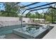 A luxurious in-ground pool is the centerpiece of this outdoor oasis with spa and lounge seating at 1616 Turnbull Crossings Dr, New Smyrna Beach, FL 32168