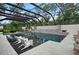 Resort-style pool area with a built-in spa, lush landscaping, and ample lounging space at 1616 Turnbull Crossings Dr, New Smyrna Beach, FL 32168