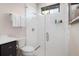 Modern shower with white tiled walls, glass door, and sleek fixtures at 1616 Turnbull Crossings Dr, New Smyrna Beach, FL 32168