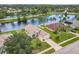 A beautiful aerial view of a single-Gathering home on a waterfront lot, enhanced by mature trees at 1809 Forough Cir, Port Orange, FL 32128