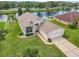 A beautiful aerial view of a single-Gathering home on a waterfront lot with a well-manicured lawn at 1809 Forough Cir, Port Orange, FL 32128
