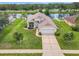 A captivating aerial view of a single-Gathering home on a waterfront lot with mature palm trees at 1809 Forough Cir, Port Orange, FL 32128