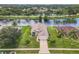 A panoramic aerial view of a waterfront community featuring well-maintained homes, lush landscaping and mature trees at 1809 Forough Cir, Port Orange, FL 32128