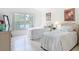 Bright bedroom with twin beds, white furniture, and a large window offering a serene lake view at 1809 Forough Cir, Port Orange, FL 32128