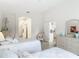 Airy bedroom featuring twin beds and wicker furniture, leading to an open view of the en-suite and closets at 1809 Forough Cir, Port Orange, FL 32128