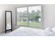 Bright bedroom with a waterfront view, showcasing large windows and neutral decor for a peaceful ambiance at 1809 Forough Cir, Port Orange, FL 32128