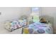 Inviting bedroom with twin beds, a bright window, and comfortable furnishings at 1809 Forough Cir, Port Orange, FL 32128