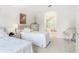 Cozy bedroom with twin beds and wicker furniture, offering an open view into the en-suite bathroom at 1809 Forough Cir, Port Orange, FL 32128