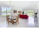 Open-concept dining room with a glass table, seating for six, with view of pond at 1809 Forough Cir, Port Orange, FL 32128