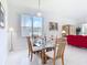 Open-concept dining room with a glass table, seating for four, and view of lanai at 1809 Forough Cir, Port Orange, FL 32128