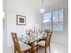 Dining room featuring a glass table, seating for four, and a large window at 1809 Forough Cir, Port Orange, FL 32128