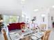 Open-concept dining room with a glass table, seating for six, with view of pond at 1809 Forough Cir, Port Orange, FL 32128