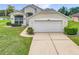 A charming single-Gathering home with a well-manicured lawn, arched window and a two-car garage at 1809 Forough Cir, Port Orange, FL 32128