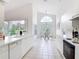 Bright eat-in kitchen with vaulted ceiling, all white cabinets and adjacent breakfast nook at 1809 Forough Cir, Port Orange, FL 32128