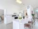 Bright kitchen featuring white cabinets, a breakfast bar, and modern appliances at 1809 Forough Cir, Port Orange, FL 32128