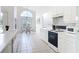 Bright eat-in kitchen with vaulted ceiling, all white cabinets and adjacent breakfast nook at 1809 Forough Cir, Port Orange, FL 32128